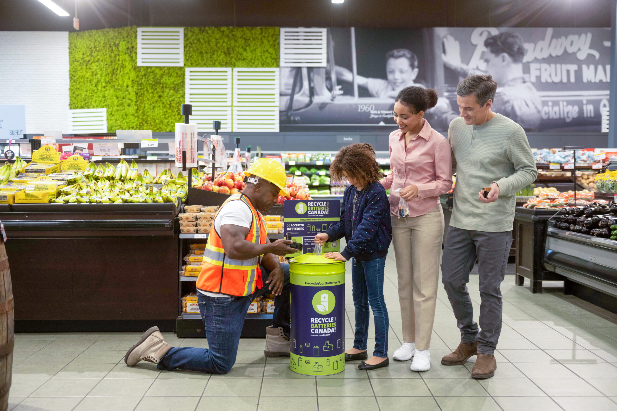 Group of people recycling batteries at grocery store scaled