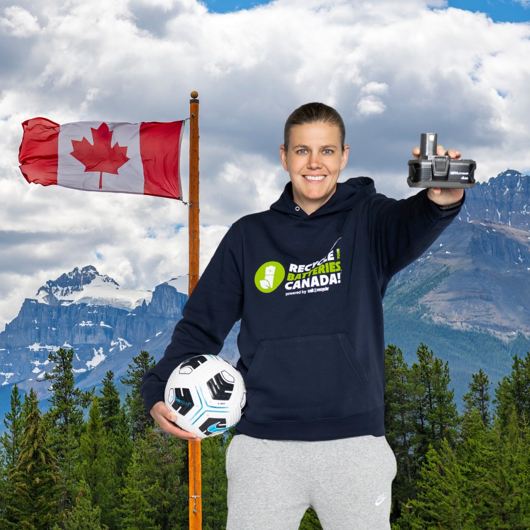 Christine Sinclair holding a rechargeable battery against Canadian nature scenery background