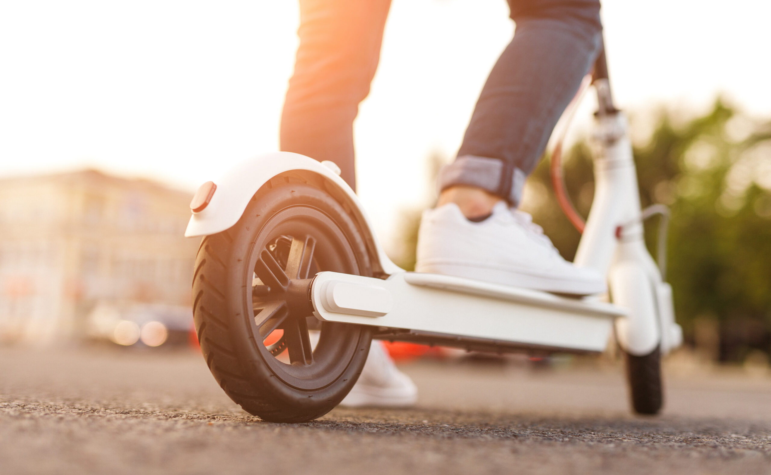 Crop man riding electric scooter